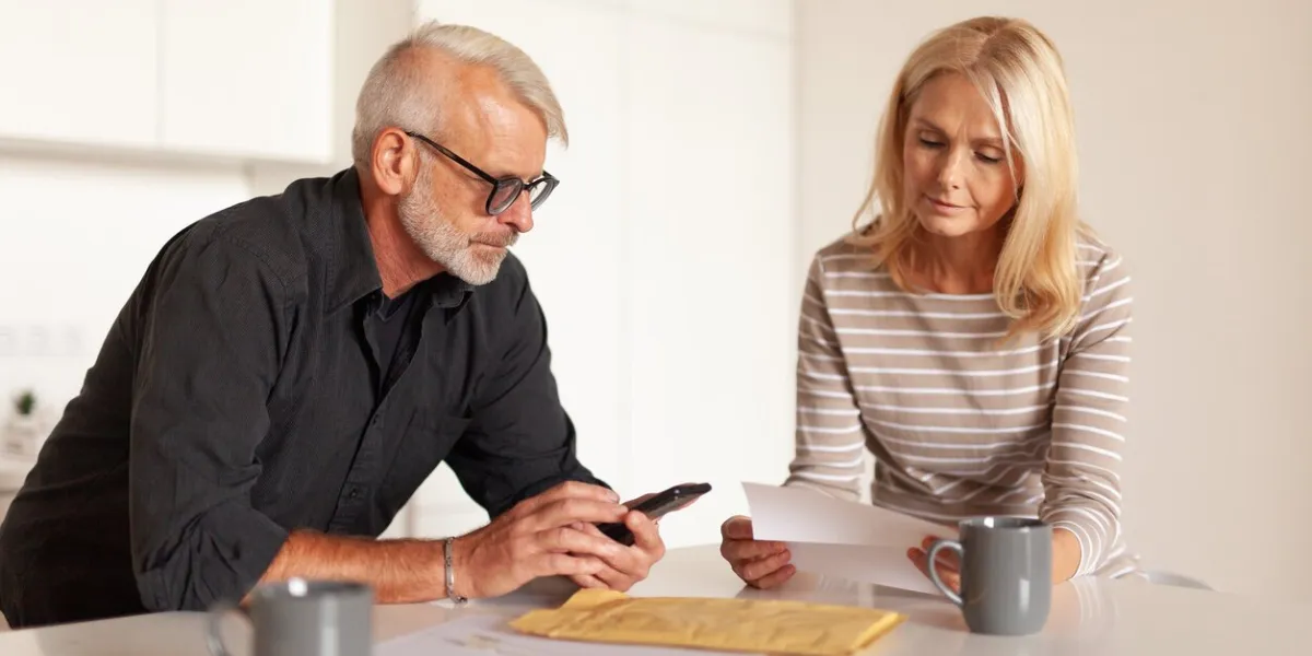 mature people family expenses senior husband and wife read the financial statement upset people look at bills, report by mail