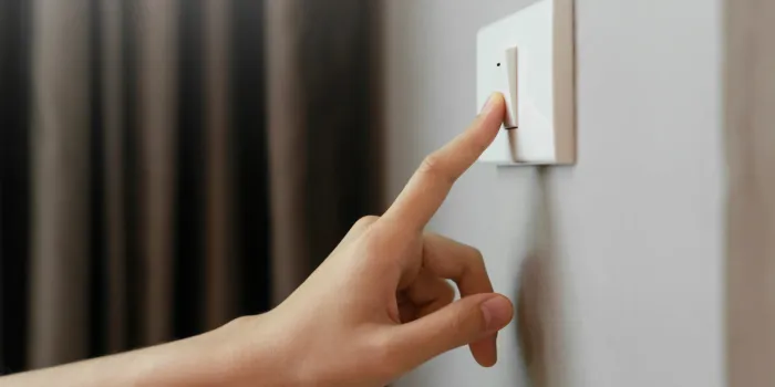 close up of female finger is turn off on lighting switch at home power, energy, saving electrical, copy space