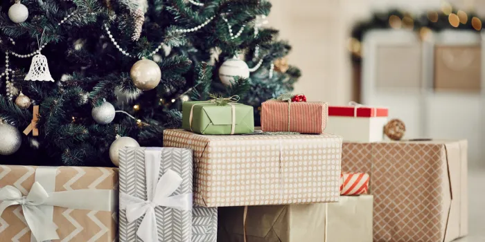 close-up of christmas presents in wrapping paper are on the floor under the christmas tree