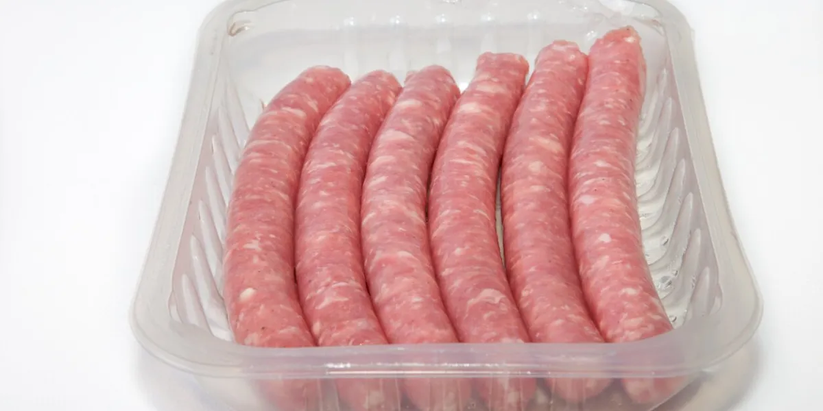 spicy pork sausages on the package, isolated on white background