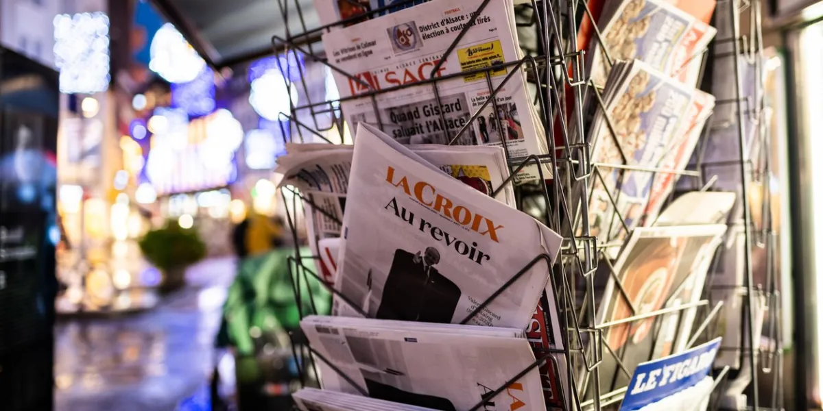 strasbourg, france - dec 4, 2020  au revoir goodbye text on la croix newspaper at french press kiosk announcing the death of valery giscard d'estaing french politician who served as president of france