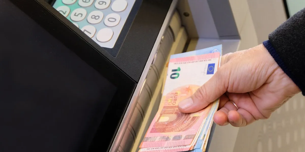 vannes, france, january 7, 2022  withdrawing euro banknotes from a cash machine