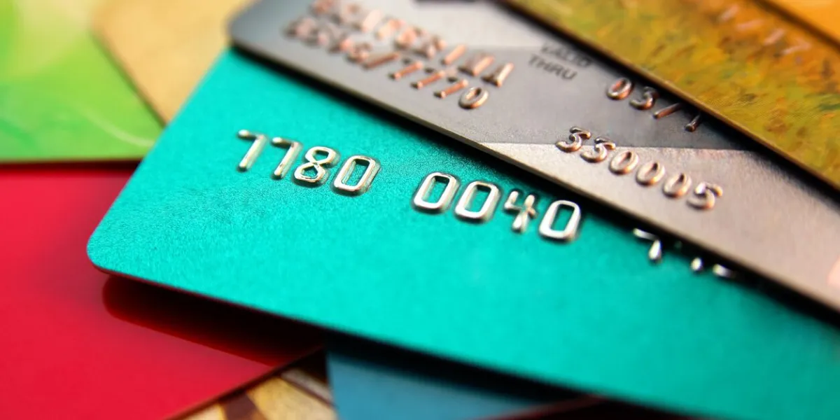 stack of multicolored credit cards, close up view with selective focus