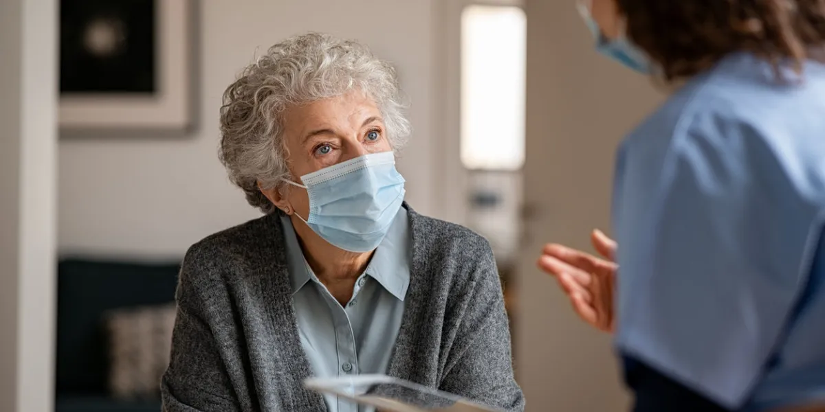 doctor home visit a senior woman during the covid-19 pandemic