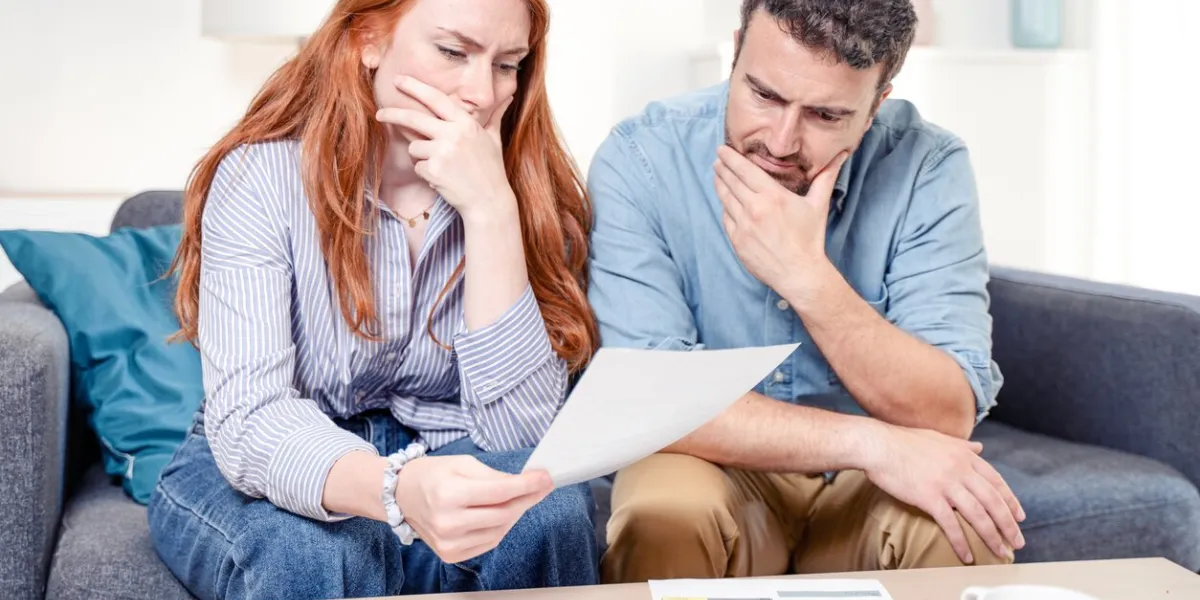 young caucasian couple having debt problems after home expenses