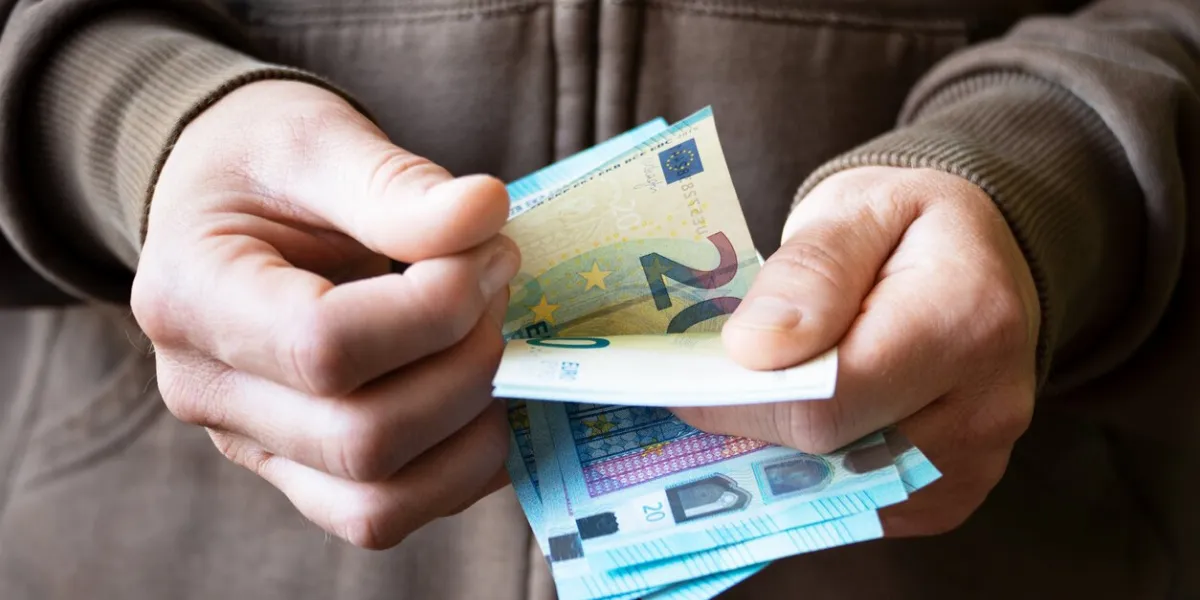 white male count euro bills in her hands