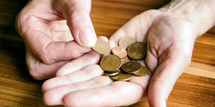 euro coins in hand of senior