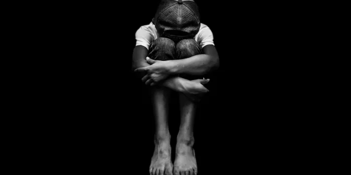 young asian boy, scared and alone hoping for a better future than the one that seems set he is at high risk of being physically, mentally and emotionally abused and also trafficked