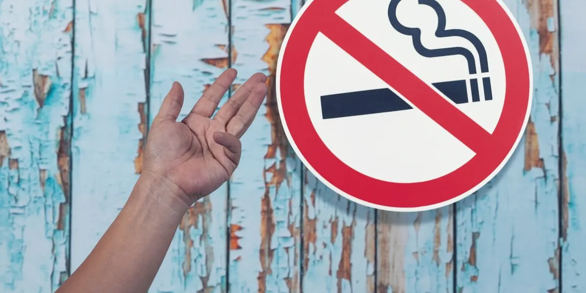 no smoking sign with hand on wall backgroundhealth concept
