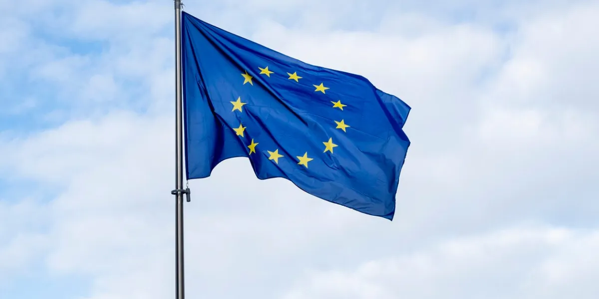 panoramic view of a waving eu flag or european union flag against blue sky