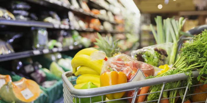close up of full shopping cart in grocery store