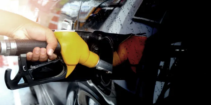 colorful fuel gasoline dispenser with sun flare background