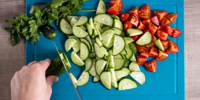 top view of a woman cooking healthy food slicing vegetables hands on the image