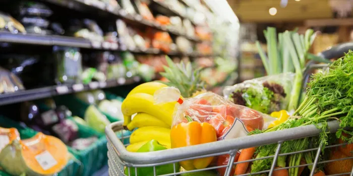 close up of full shopping cart in grocery store