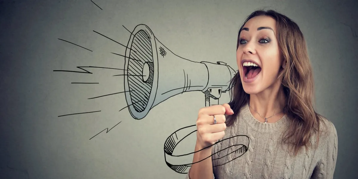 content young woman screaming in loudspeaker making announcement