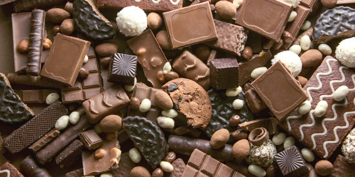 chocolate background many pieces of chocolate, candies, cookies, biscuits, cakes and other sweets milk chocolate and dark chocolate coconut candy