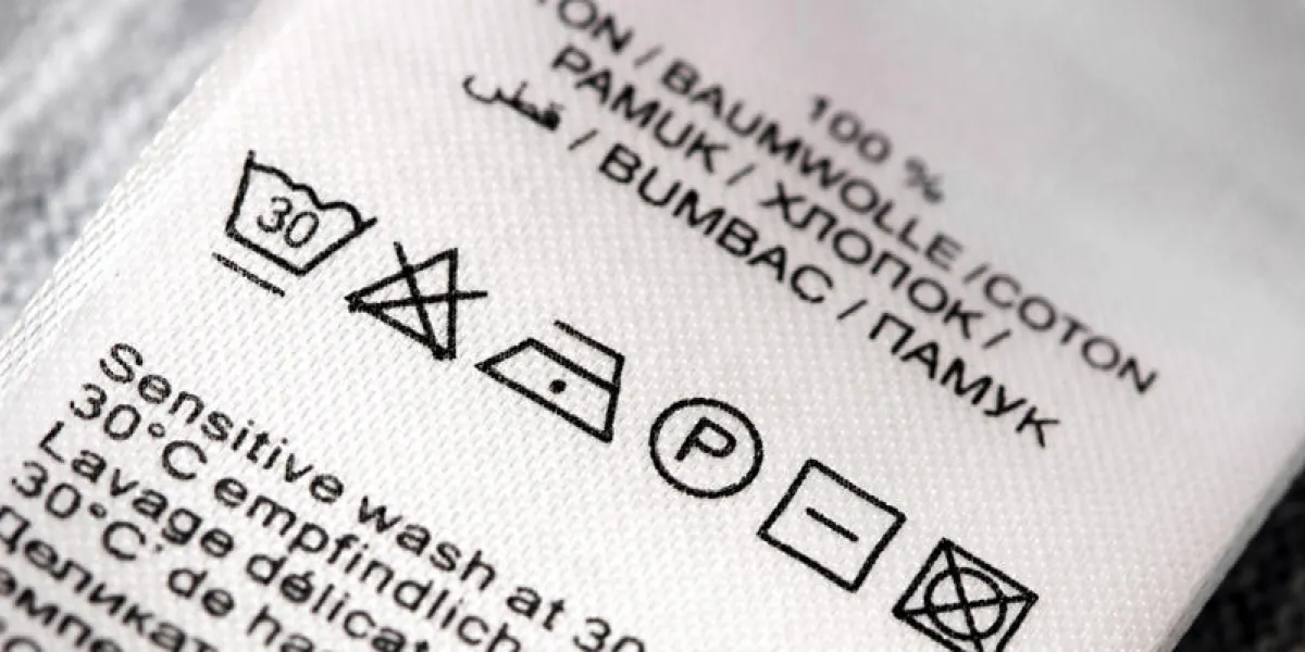 clothing labels with laundry care symbols close-up shallow dof