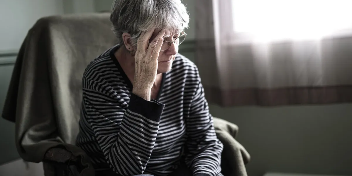 a worried senior woman at home felling very bad