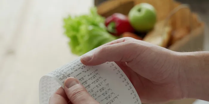 close-up woman looking a check from a supermarket expense tracking and budgeting