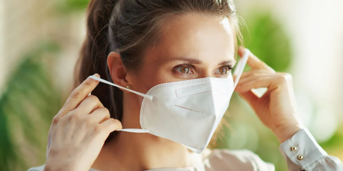 covid-19 pandemic middle aged woman in grey blouse wearing ffp2 mask