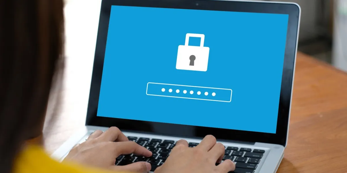 hand tying laptop computer with password login on screen, cyber security concept