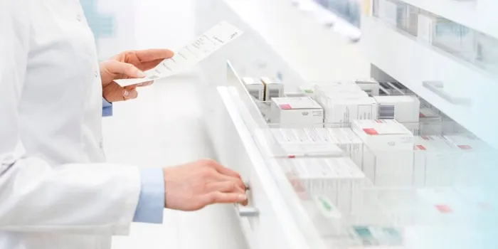 pharmacist filling prescription in pharmacy