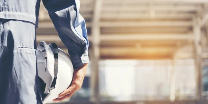 construction engineer in safety suit trust team holding white yellow safety hard hat security equipment on construction site hardhat protect head for civil construction engineer engineering concept