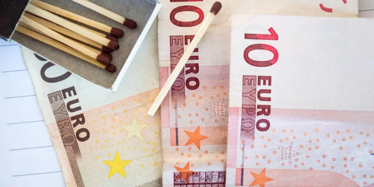 euro notes visible a box of matches is visible, along with a single match, to show the frustration that can come with managing finances