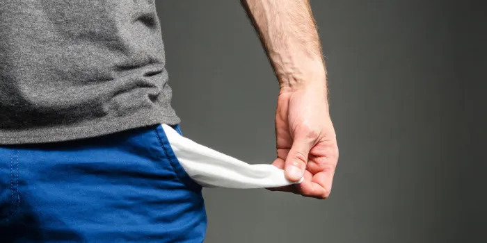 image of a male holding out his empty pockets