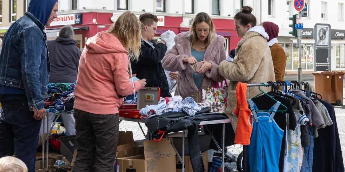 neuwied, germany - september 17, 2022 buyers on a flea market pay for something they bought