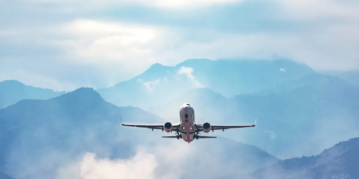 jet flight travel concept stock photo airplane fly above amazing blue misty mountains