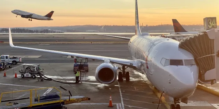 an american airline airplane sits at a gate at washington reagan national airport on december 8, 2019 (photo by daniel slim   afp)