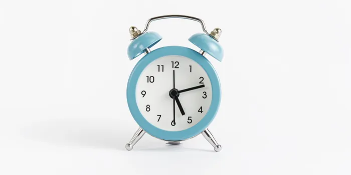 blue alarm clock on white background time and deadline concept