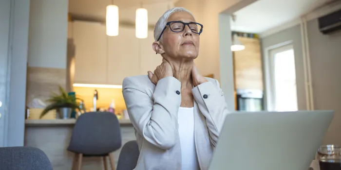 cropped shot of a mature businesswoman looking stressed out while working in her office at home mature businesswoman having neck pain stressed mature woman massaging her neck