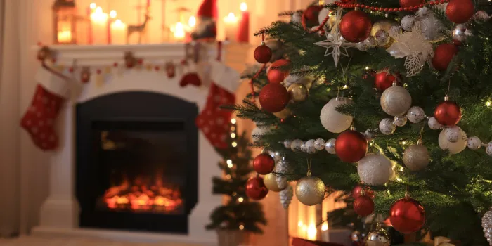 festive living room interior with christmas tree near fireplace