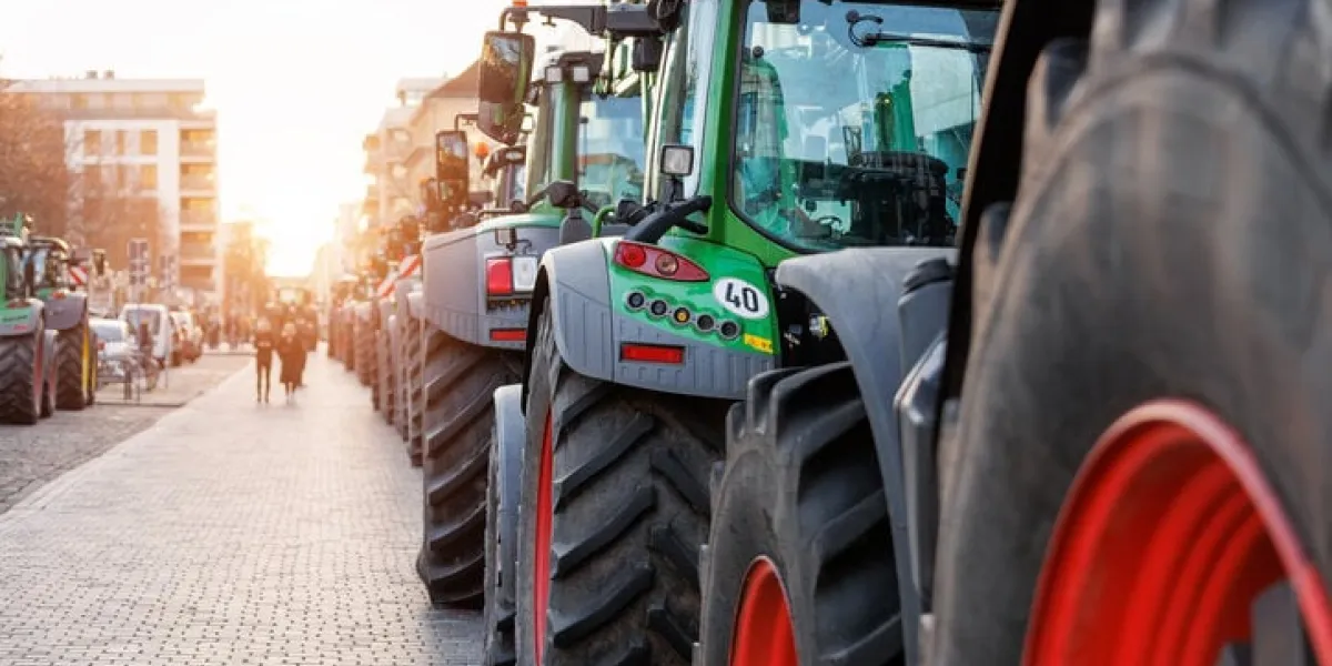 farmers union protest strike against government policy in germany europe tractors vehicles blocks city road traffic agriculture farm machines magdeburg central domplatz square